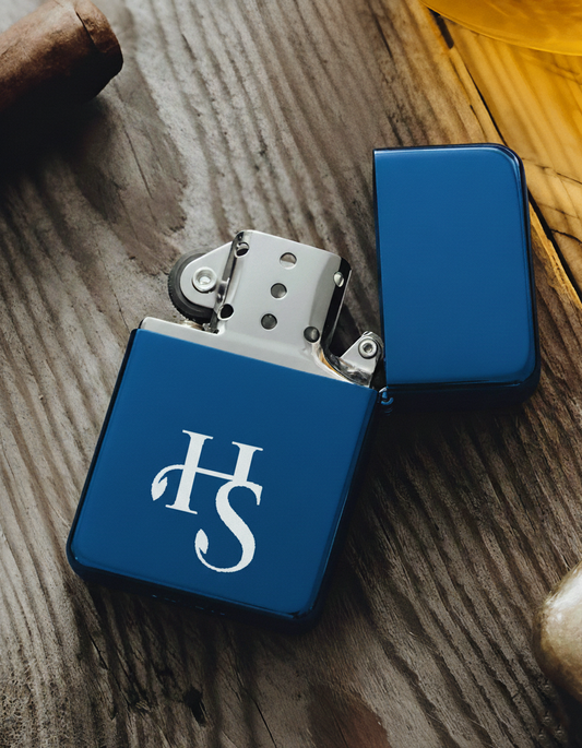 Refillable blue metal lighter with open lid, featuring a flint wheel and windproof chimney. Displayed on a wooden surface for a sleek, modern product showcase.